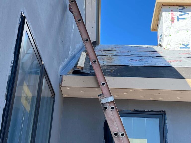 EIFS roof-to-wall waterproofing and drainage detail during exterior wall installation